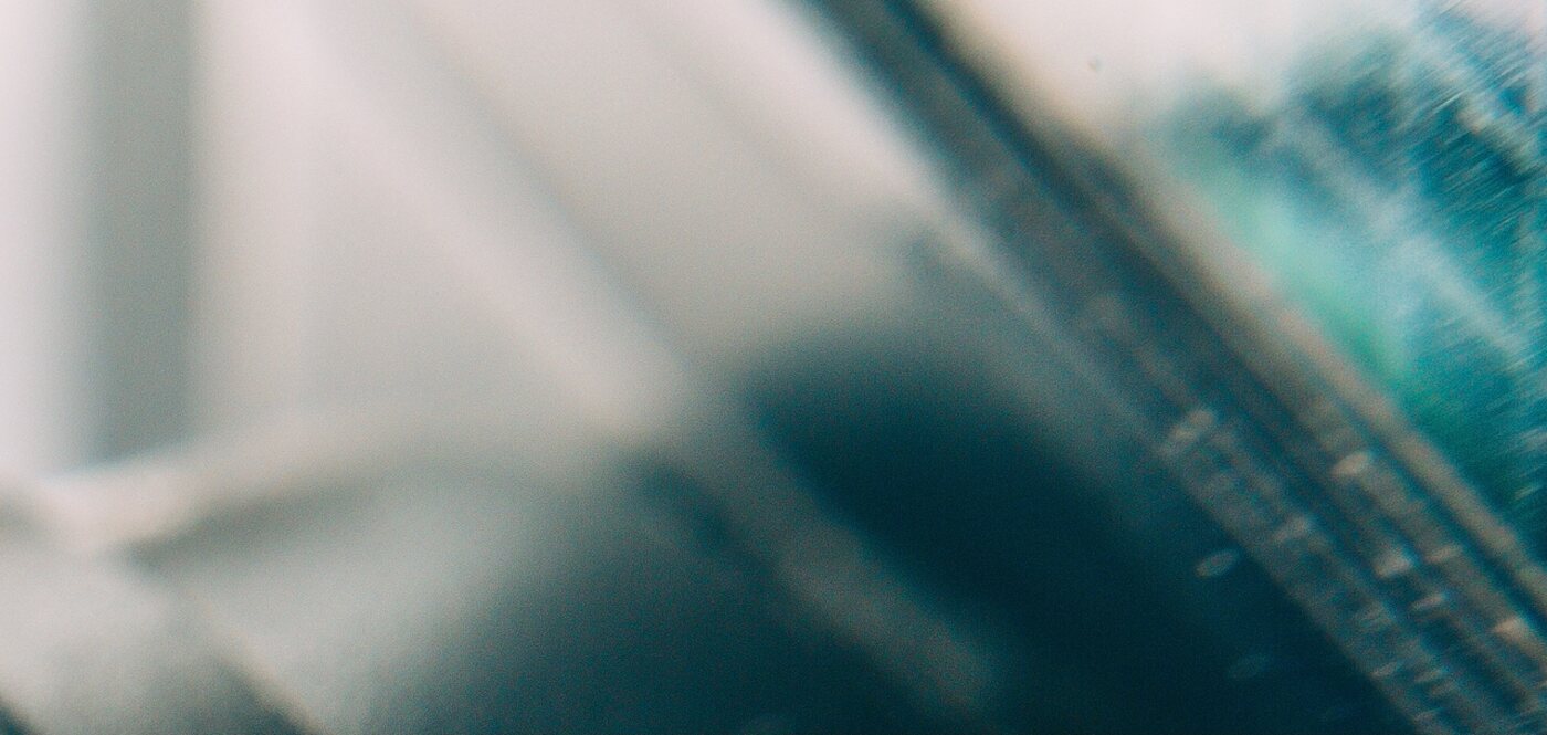 Teal close-up of a screen in soft daylight.